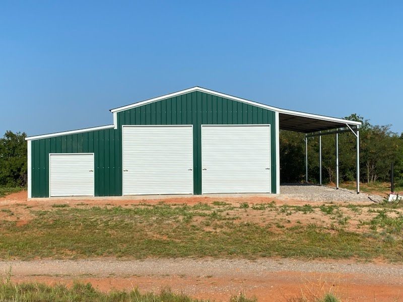 Green Legacy agricultural barn with garage doors and an open lean-to